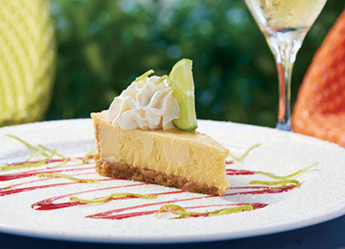 Key Lime Pie with whipped cream on top with a slice of lime